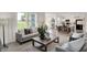Spacious living room with hardwood floors, large windows, and seamless transition to the kitchen at 11840 Vale St, Indianapolis, IN 46235