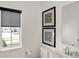 Clean powder room with modern fixtures, decorative art, and a bright window for ample light at 11840 Vale St, Indianapolis, IN 46235