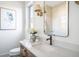 Bathroom showcasing white countertop, natural wood vanity, and decorative floral arrangement at 11904 Spring Mill Rd, Carmel, IN 46032