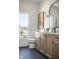 Bathroom with black hexagon tile floors, and wooden vanity with matte black hardware, and a large window at 11904 Spring Mill Rd, Carmel, IN 46032