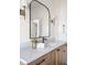Bathroom boasts a wood vanity with quartz countertops, black hardware, and a black-framed mirror at 11904 Spring Mill Rd, Carmel, IN 46032