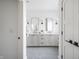 Spacious bathroom with a double sink vanity, white countertops, and modern fixtures at 11904 Spring Mill Rd, Carmel, IN 46032