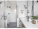 Modern bathroom featuring a glass enclosed shower, and a bright vanity with black hardware and white countertops at 11904 Spring Mill Rd, Carmel, IN 46032