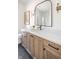 Well-lit bathroom features a wood vanity with quartz countertops, black hardware, and black-framed mirror at 11904 Spring Mill Rd, Carmel, IN 46032