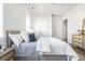 Bedroom with a gray bed, nightstand, and white walls, plus ensuite bathroom access at 11904 Spring Mill Rd, Carmel, IN 46032