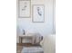 Bedroom seating area with blue heron artwork, bench with cushions, and hardwood flooring at 11904 Spring Mill Rd, Carmel, IN 46032