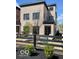 Modern brick home featuring a well-manicured yard and black fence at 11904 Spring Mill Rd, Carmel, IN 46032
