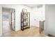 Bright hallway features hardwood floors, white walls, and modern shelving at 11904 Spring Mill Rd, Carmel, IN 46032
