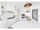 Modern kitchen with white cabinets, quartz countertops, and stainless steel appliances at 11904 Spring Mill Rd, Carmel, IN 46032