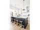Spacious kitchen island with seating, pendant lighting, and modern design elements at 11904 Spring Mill Rd, Carmel, IN 46032