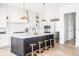 Stylish kitchen featuring a large island with seating, pendant lighting, and stainless steel appliances at 11904 Spring Mill Rd, Carmel, IN 46032