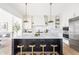 Bright, open kitchen with a large island and stainless steel appliances at 11904 Spring Mill Rd, Carmel, IN 46032