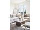 Cozy living room featuring hardwood floors, lots of natural light, and comfortable sofas and chairs at 11904 Spring Mill Rd, Carmel, IN 46032
