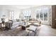Bright living room with large windows, hardwood floors, and comfortable seating creating an inviting atmosphere at 11904 Spring Mill Rd, Carmel, IN 46032