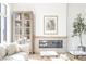 Relaxing living room showcasing a modern fireplace, hardwood floors, and a decorative built-in cabinet at 11904 Spring Mill Rd, Carmel, IN 46032