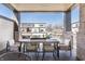 Relaxing covered patio with a dining table and views of the surrounding neighborhood at 11904 Spring Mill Rd, Carmel, IN 46032