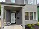 Stylish gray home featuring a covered entryway, modern lighting, and a contemporary design at 1215 Herbert St, Indianapolis, IN 46202