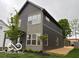 Modern two-story home with gray siding and multiple windows allowing for lots of natural light at 1215 Herbert St, Indianapolis, IN 46202
