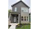 Charming two-story home featuring gray siding, a covered porch, and contemporary design elements at 1215 Herbert St, Indianapolis, IN 46202