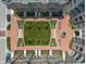 Overhead shot of landscaped courtyard with walkways, plantings, fountain, and seating areas, surrounded by residential buildings at 127 Monon Green Blvd, Carmel, IN 46032