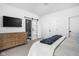 Bright bedroom with TV, dresser, and door to a walk-in shower at 127 Monon Green Blvd, Carmel, IN 46032