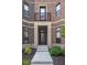 Inviting front entryway with a private terrace, modern door and elegant stone steps at 127 Monon Green Blvd, Carmel, IN 46032