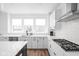 Bright kitchen features white cabinetry, stainless steel appliances, and a stylish black and white island at 127 Monon Green Blvd, Carmel, IN 46032