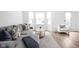 Inviting living room featuring a comfortable gray sectional, stylish pillows, and plenty of natural light at 127 Monon Green Blvd, Carmel, IN 46032