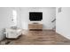 Minimalist living room featuring a console cabinet, a sleek TV, and a stylish armchair at 127 Monon Green Blvd, Carmel, IN 46032