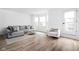 Bright and airy living room with a gray sofa, modern decor, and ample natural light from large windows at 127 Monon Green Blvd, Carmel, IN 46032