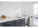 Elegant wet bar features marble countertops, stainless steel sink, wine fridge, and ample cabinet space at 127 Monon Green Blvd, Carmel, IN 46032