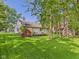 Spacious backyard with mature trees, featuring a deck, and a privacy fence, perfect for outdoor entertaining at 1356 S Catamaran Cir, Cicero, IN 46034