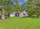 View of the side and backyard of the home, showcasing a spacious, well-kept lawn at 1356 S Catamaran Cir, Cicero, IN 46034