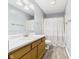 Bathroom featuring a sink with a wooden vanity, a mirror, and a shower with gray wood look flooring at 1356 S Catamaran Cir, Cicero, IN 46034