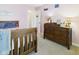 Cozy bedroom with warm pink walls, carpeted floor, and wood furnishings, perfect for a restful sleep at 1356 S Catamaran Cir, Cicero, IN 46034