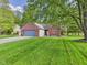 Charming brick home featuring a well-manicured lawn and attached two-car garage at 1356 S Catamaran Cir, Cicero, IN 46034