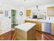 Well-lit kitchen boasts wood cabinets, ample counter space, and a view into the adjacent living area at 1356 S Catamaran Cir, Cicero, IN 46034