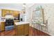 Bright kitchen featuring wood cabinets, stainless steel appliances, and a charming breakfast nook with a large window at 1356 S Catamaran Cir, Cicero, IN 46034