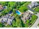 Overhead shot of neighboring luxury homes showcasing pools, landscaped yards, and lush trees from above at 13827 Driftwood Dr, Carmel, IN 46033
