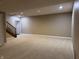 Spacious basement with neutral carpet, stairs, and recessed lighting at 13827 Driftwood Dr, Carmel, IN 46033