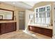Bright bathroom with soaking tub, large window, walk-in shower, and double vanity at 13827 Driftwood Dr, Carmel, IN 46033