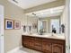 Bathroom featuring double sinks, framed art, and a large mirror at 13827 Driftwood Dr, Carmel, IN 46033