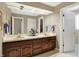 Bathroom with a double sink vanity, large mirror, and neutral decor at 13827 Driftwood Dr, Carmel, IN 46033