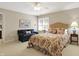 Bedroom with a floral bedspread, blue sofa, and a window for natural light at 13827 Driftwood Dr, Carmel, IN 46033