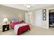 Comfortable carpeted bedroom with neutral colors, ceiling fan, closet, and two lamps on bedside tables at 13827 Driftwood Dr, Carmel, IN 46033