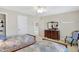 Bright bedroom with two beds, dresser, and a decorative chair at 13827 Driftwood Dr, Carmel, IN 46033