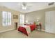 Bedroom featuring two windows with blinds, carpet, ceiling fan, and a bed with red and plaid accents at 13827 Driftwood Dr, Carmel, IN 46033