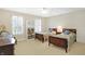 Cozy bedroom featuring two twin beds, shutters, and a built-in bookcase at 13827 Driftwood Dr, Carmel, IN 46033