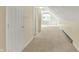 Hallway in spacious bonus room features neutral carpet, white walls, and white doors at 13827 Driftwood Dr, Carmel, IN 46033