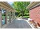 Spacious deck with seating area, offering serene views of the well-maintained backyard and greenery at 13827 Driftwood Dr, Carmel, IN 46033